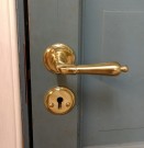 Dørvrideren og skilt montert på en dør fra 1980- tallet med gjennomgående bolter. thumbnail